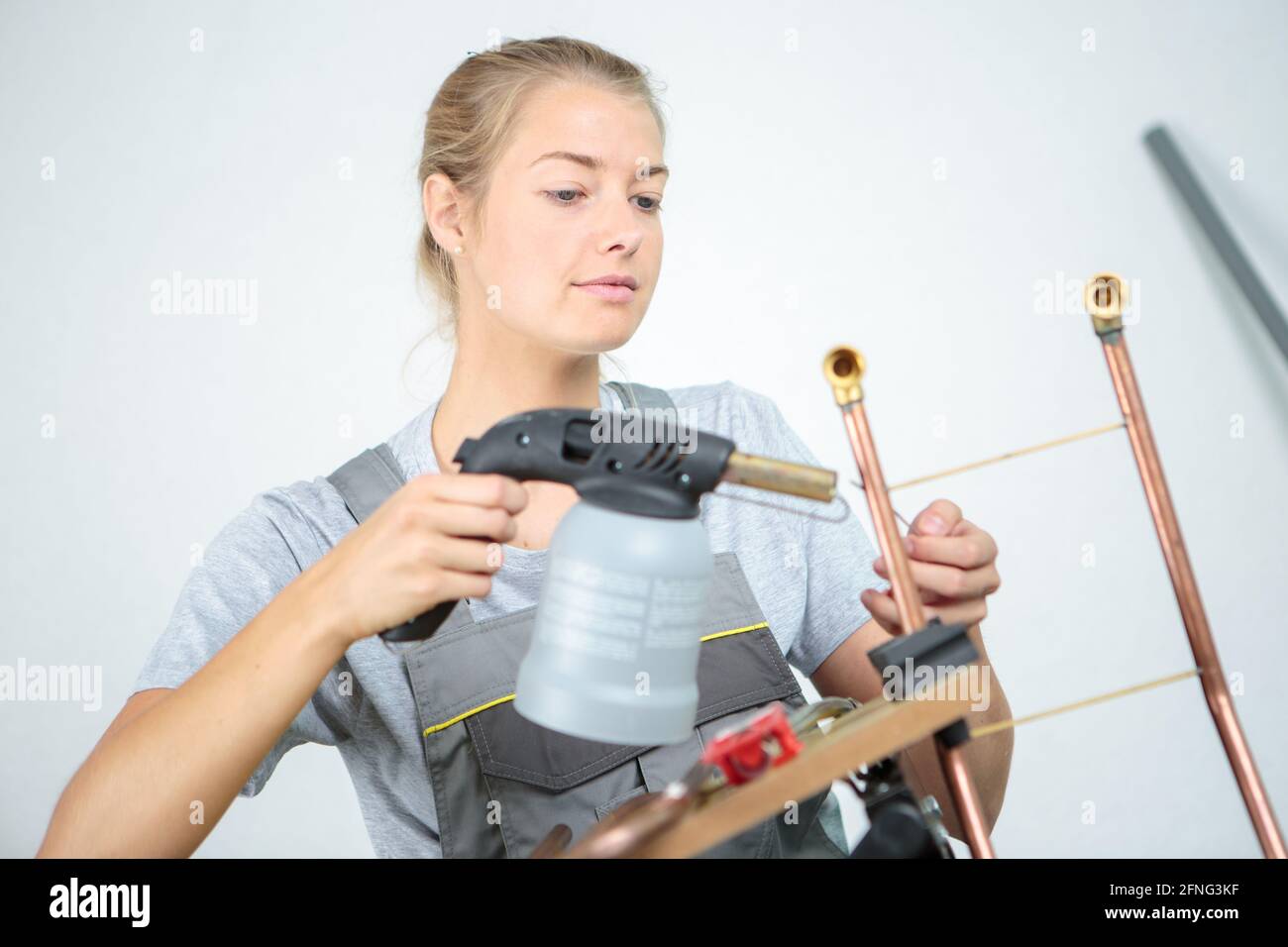 woman worker using blowtorch on copper pipe Stock Photo Alamy