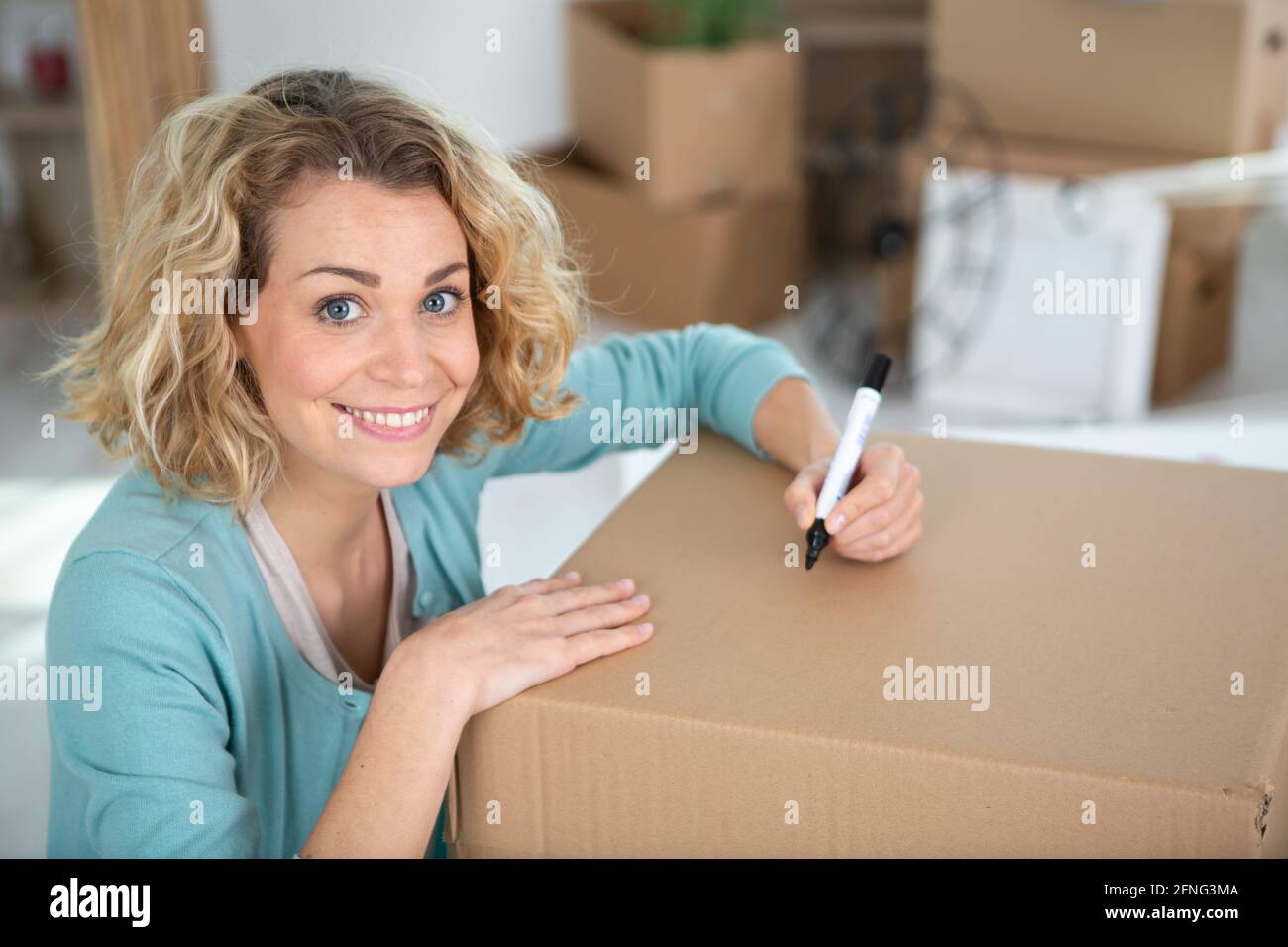 woman labeling moving box at home Stock Photo Alamy