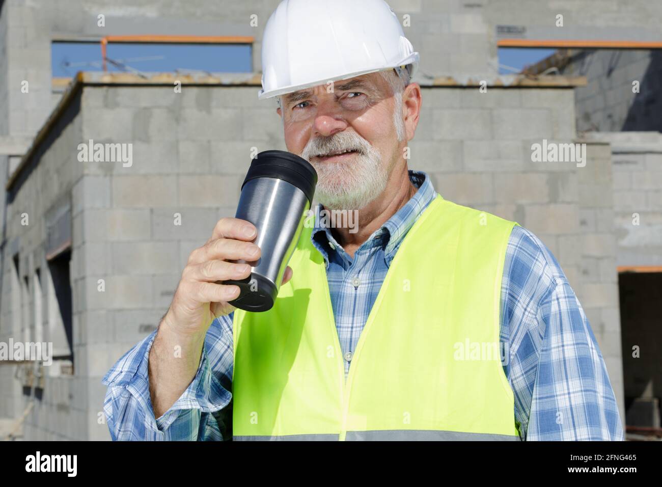 professional senior home builder engineer drinking hot coffee Stock Photo