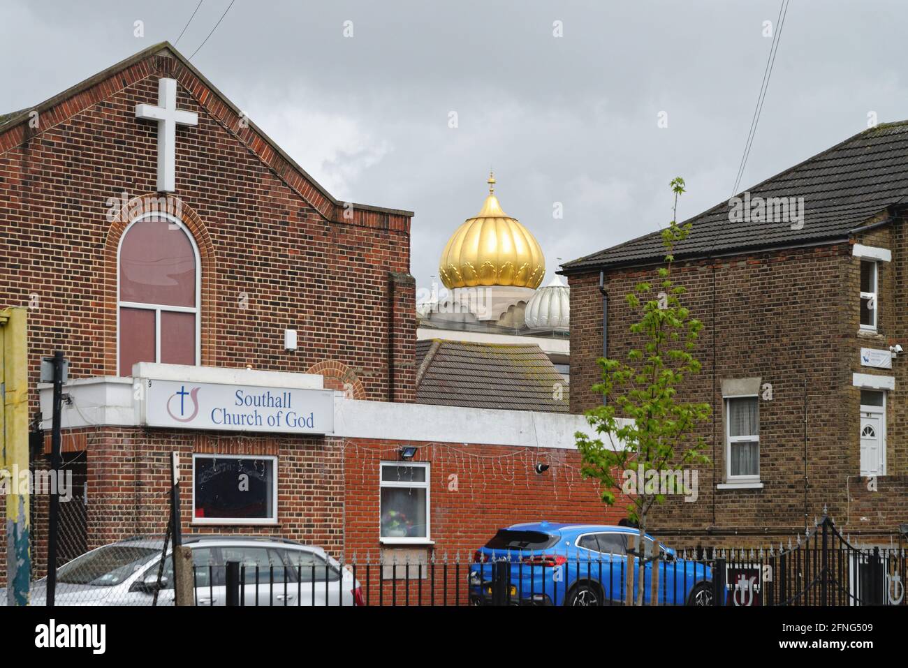 The golden dome of the Siri Guru Singh Sabha Gurdwara temple dominating the skyline in Southall London borough of Ealing England UK Stock Photo