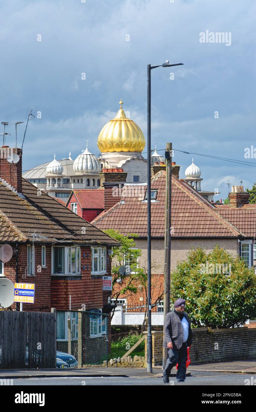 The golden dome of the Siri Guru Singh Sabha Gurdwara temple dominating the skyline in Southall London borough of Ealing England UK Stock Photo