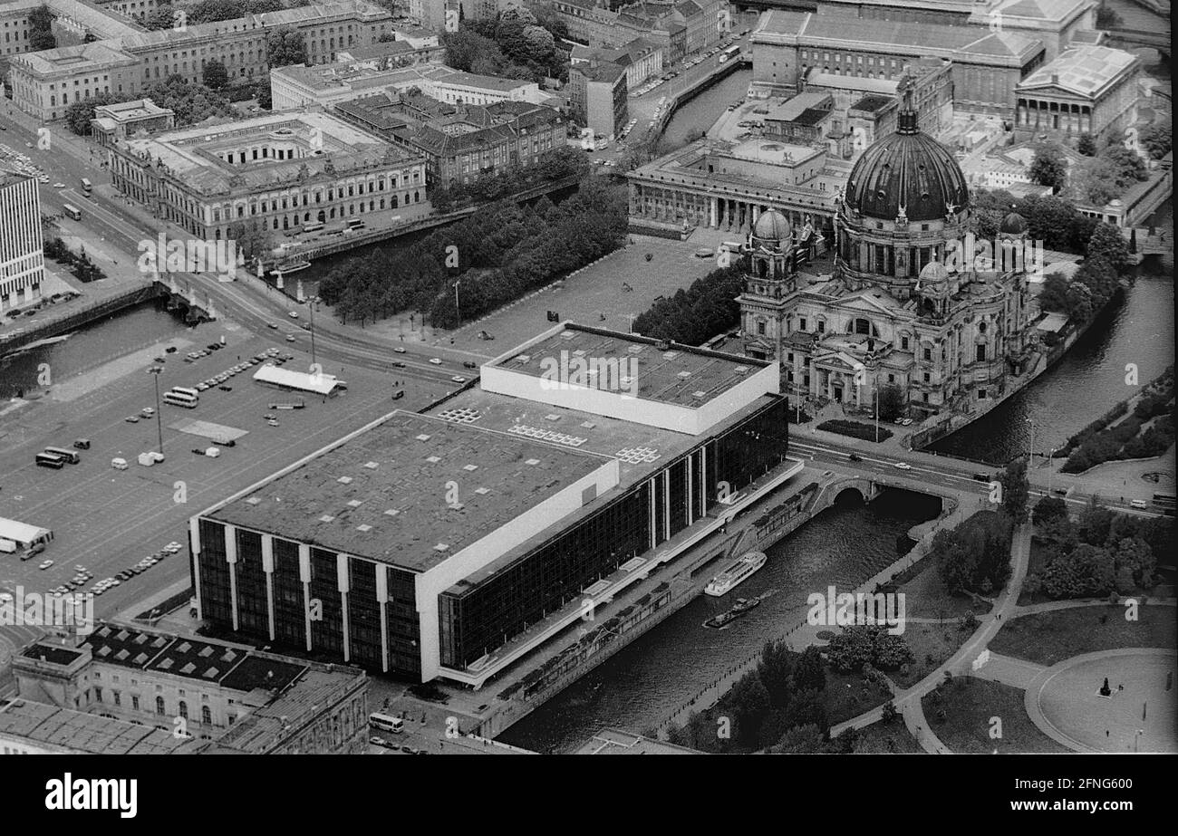 Berlin-City / GDR / 5 / 1991 The Palace of the Republic at the Schlossplatz, on the right Museum Island, on the left Unter den Linden, in front the river Spree // Mitte / Stadtschloss // Parliament /Unter den Linden / History In place of the City Palace, which was demolished in 1950, the Palace of the Republic was built from 1973 on, 180 m long, 32 m wide. In it were various facilities. In the large hall events took place, it held 5000 visitors. In the small hall the GDR chamber of people met. There were also restaurants and cafes for 1500 guests. From 2016 the new building is called Stock Photo