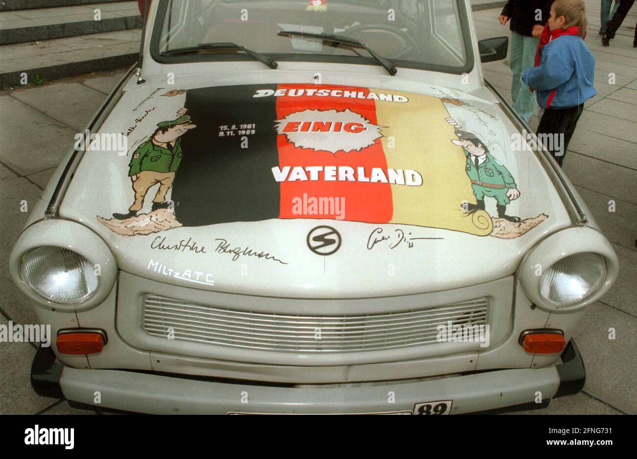 Berlin / GDR / 1995 GDR nostalgia rediscovers the Trabi as a cult vehicle. At a meeting in Berlin, a model is shown with slogans such as -Unity- -Germany united fatherland- // Trabi / symbol / [automated translation] Stock Photo