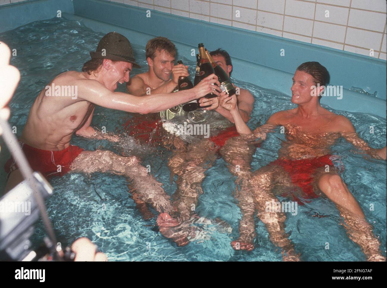 FC Bayern München German Champion 1990. The Bayern players celebrate in the fatigue pool. From left: Manfred Bender, Hans-Dieter Flick, Jürgen Kohler (hidden) and Thomas Strunz. [automated translation] Stock Photo