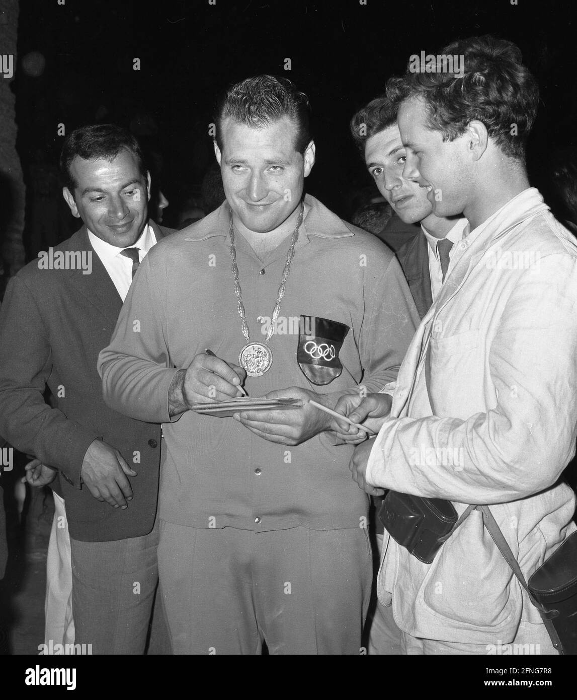 1960 Summer Olympics in Rome. Wrestling: Wilfried Dietrich (Germany) with gold medal, signs autographs 09/06/1960. [automated translation] Stock Photo