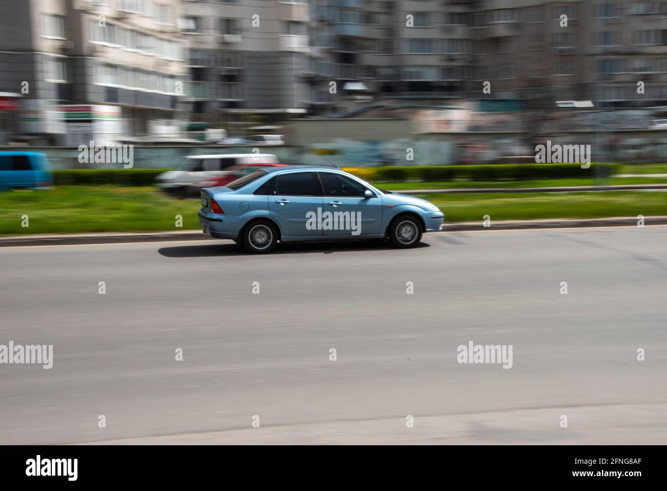 Ukraine, Kyiv - 26 April 2021: Light Blue Ford Focus car moving on the street. Editorial Stock Photo