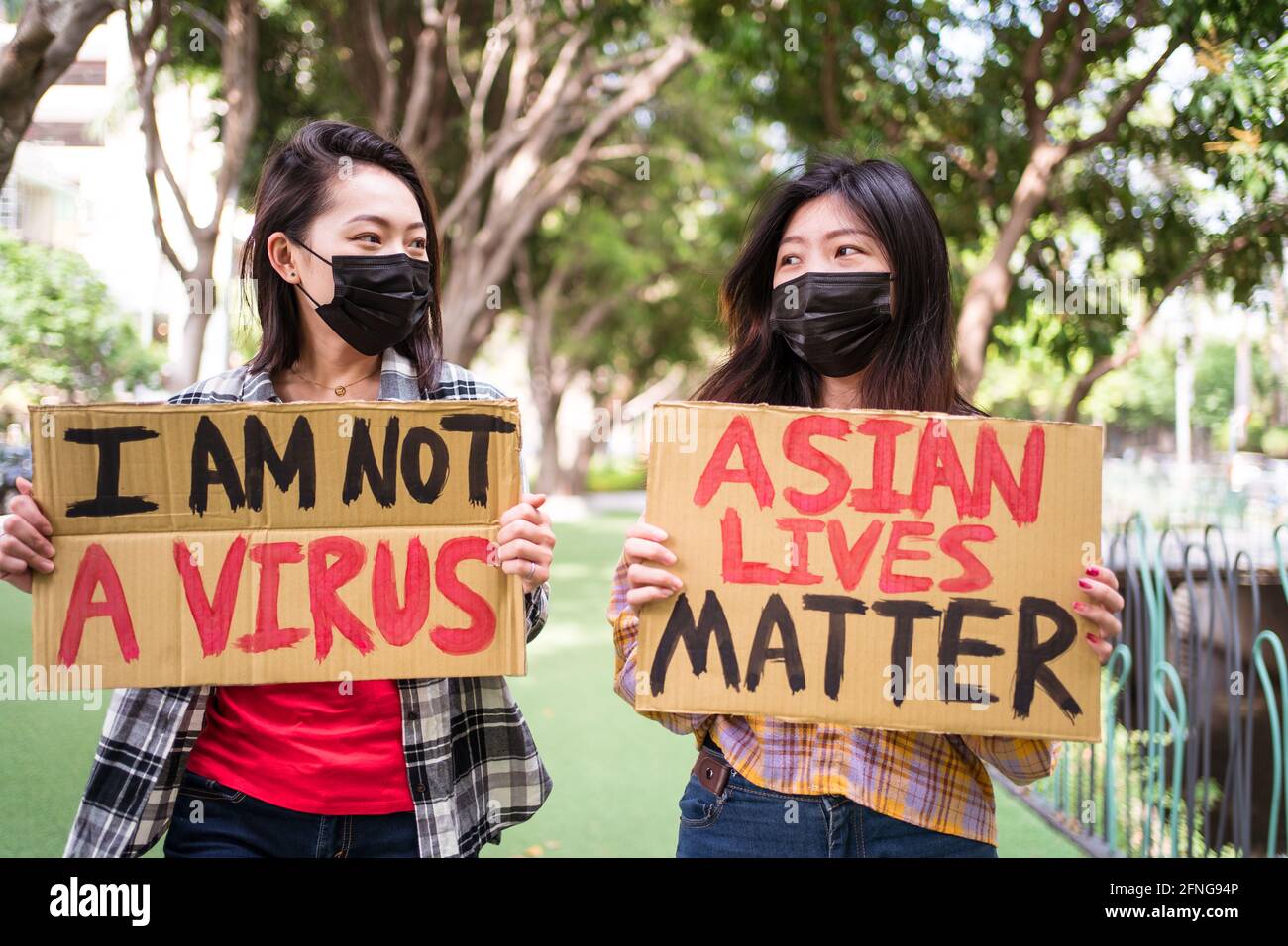 Anti Racism Mask Ethnic females in masks holding posters protesting against racism in ...