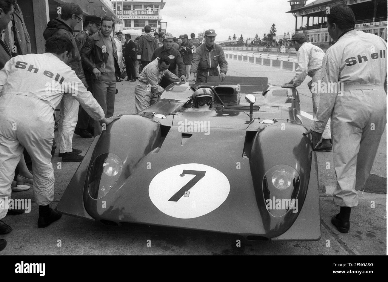 1000 km race on the Nürburgring 01.06.1969. Ferrari 312P of Pedro Rodriguez and Chris Amon at the pit with mechanics in Shell - overalls. [automated translation] Stock Photo