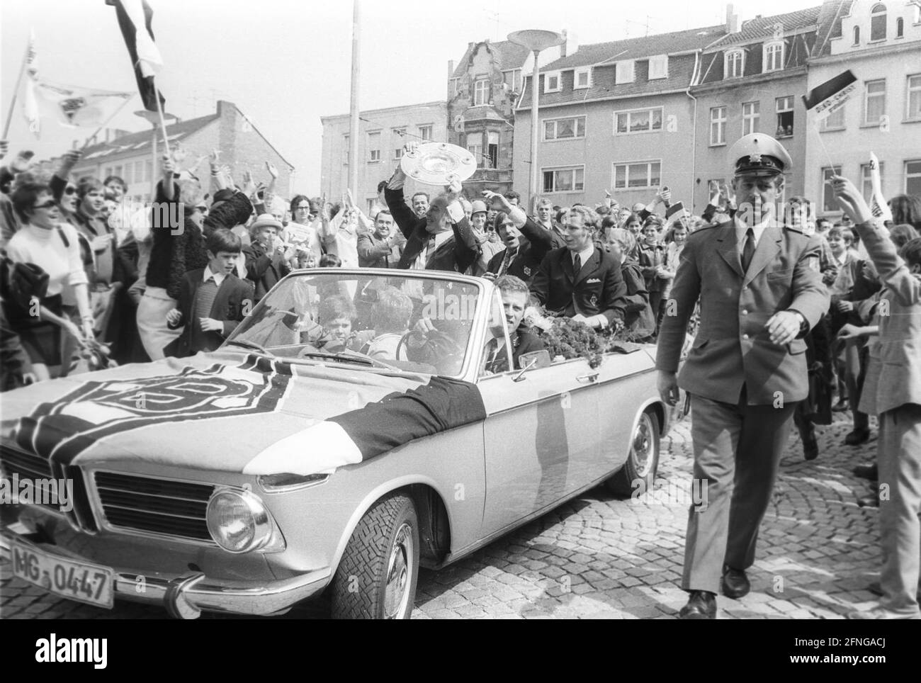 VFL Borussia Mönchengladbach German Football Champion 1969/70 during the drive through the city in the front of the car from the left coach Hennes Weisweiler, Günter Netzer and Berti Vogts with championship trophy.The motorcade is accompanied by many fans. Rec. 05.05.1970. [automated translation] Stock Photo