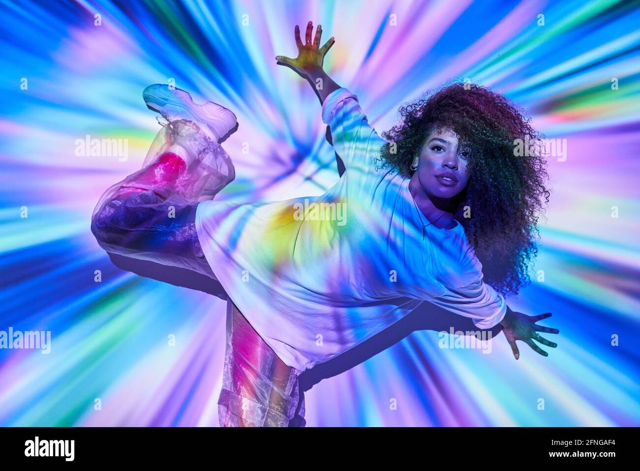Top view energetic African American female dancer in informal wear dancing  on floor and looking at camera in neon lights in dancing studio Stock Photo  - Alamy