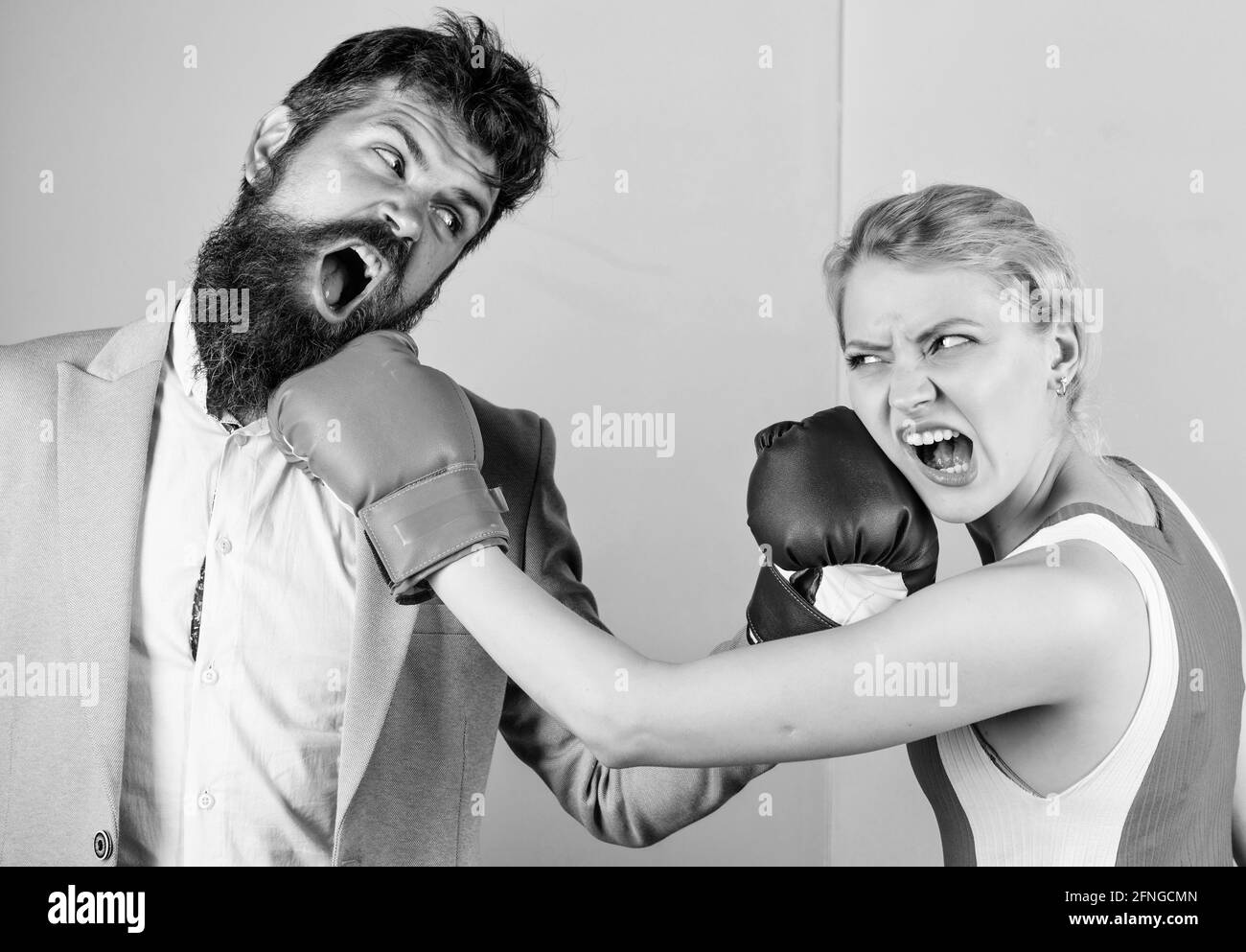 Boxers fighting in gloves. Domination concept. Gender equality. Man and