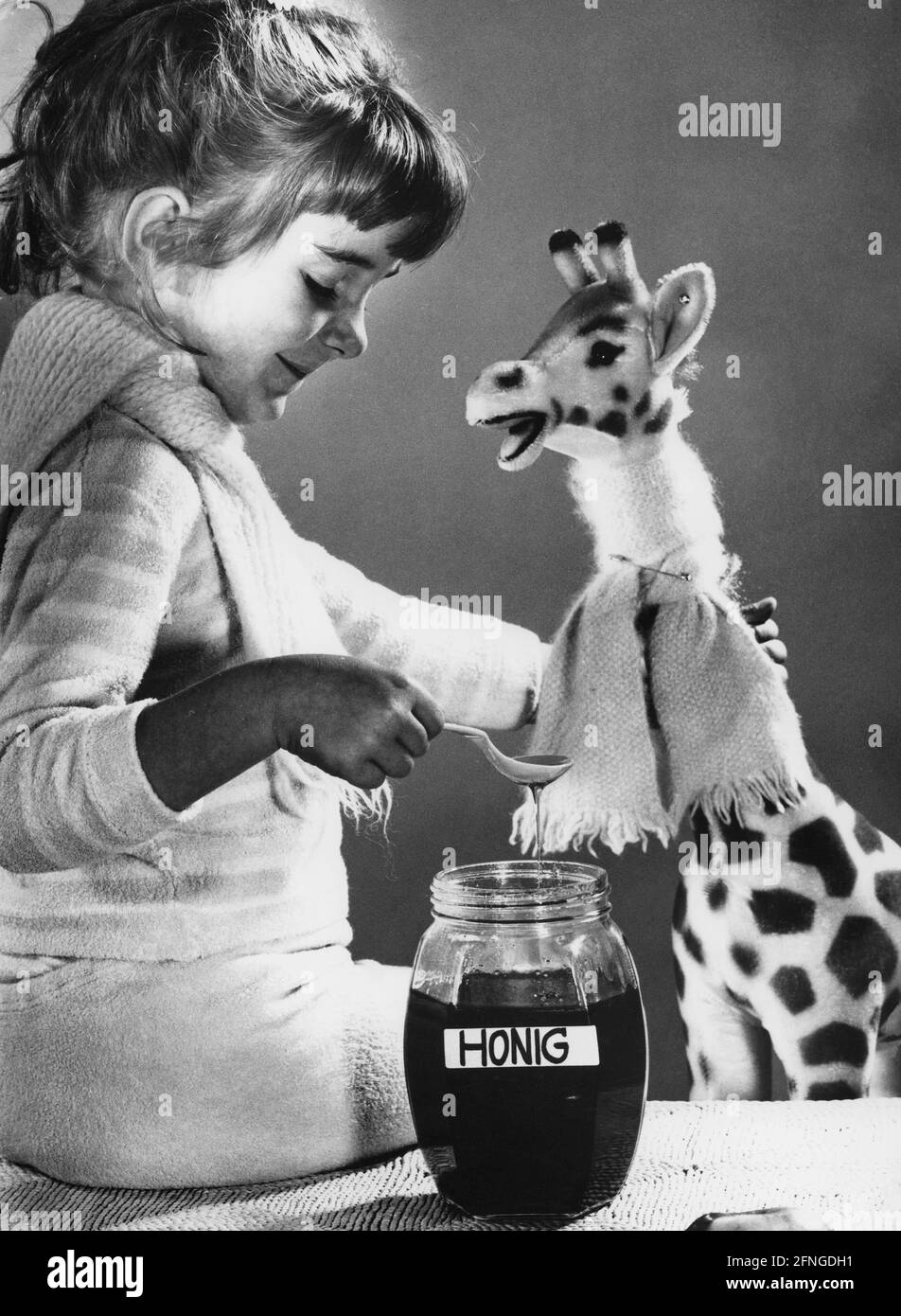 Sick girl with stuffed animal and honey jar, 60s [automated translation] Stock Photo