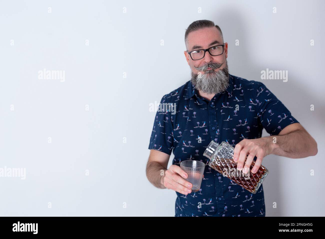 Retro look hipster with big beard and glasses, 40-45 years old, Caucasian,  holding old liquor bottle and looking straight ahead Stock Photo - Alamy