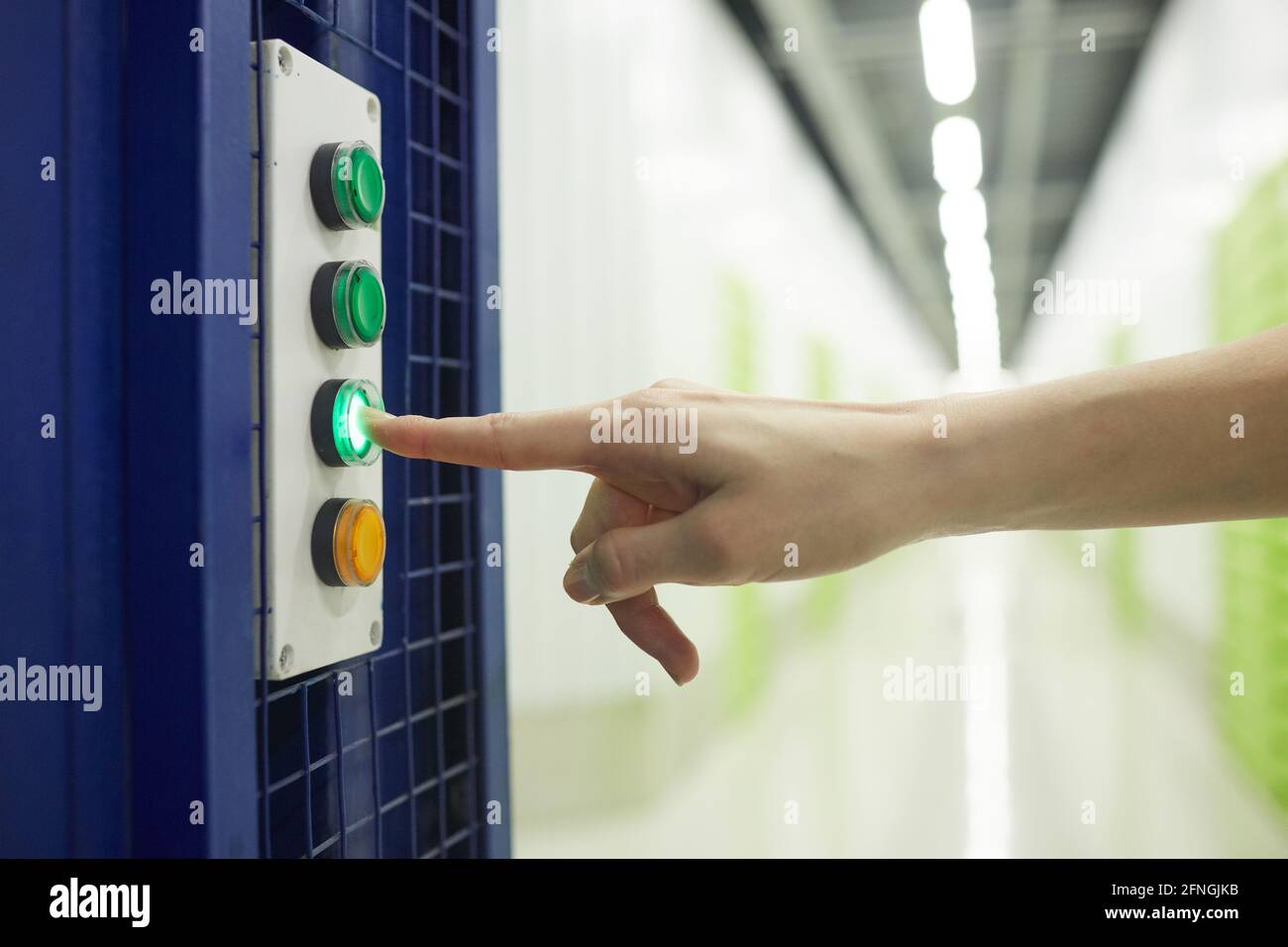 Close-up of woman pushing the button on the elevator Stock Photo