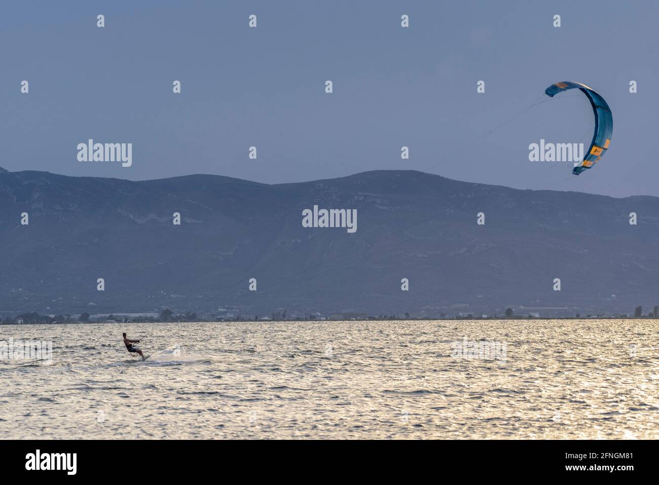 Kitesurfers at sunset in the Alfacs Bay (Ebro Delta, Tarragona, Catalonia, Spain) ESP: Practicantes de kitesurf, al atardecer, en la Badia dels Alfacs Stock Photo