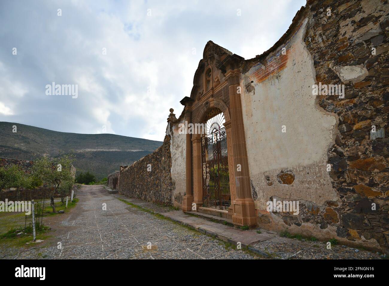Scenic landscape with view of El Paredón the historic stone wall on the exterior of Plaza de Toros in Real de Catorce, Mexico. Stock Photo