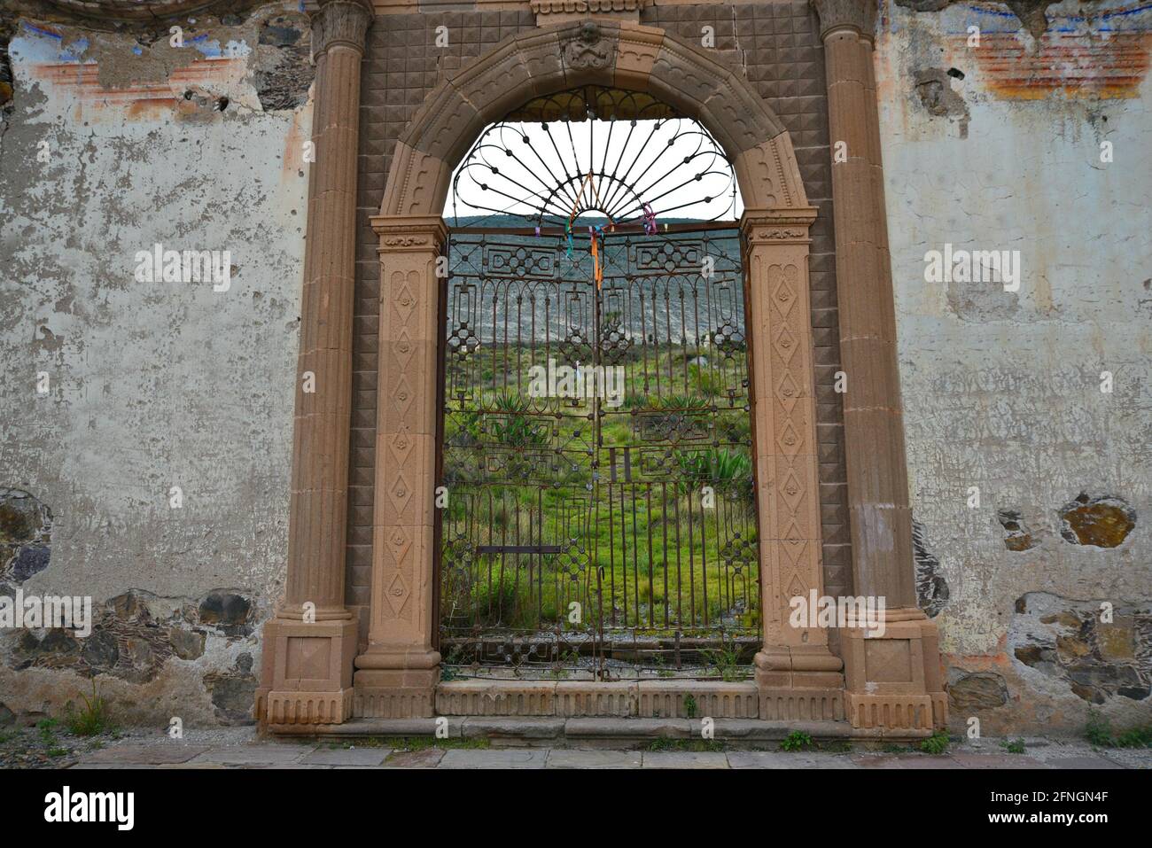 Scenic landscape with view of El Paredón arched stone entrance on the exterior of Plaza de Toros in Real de Catorce, Mexico. Stock Photo