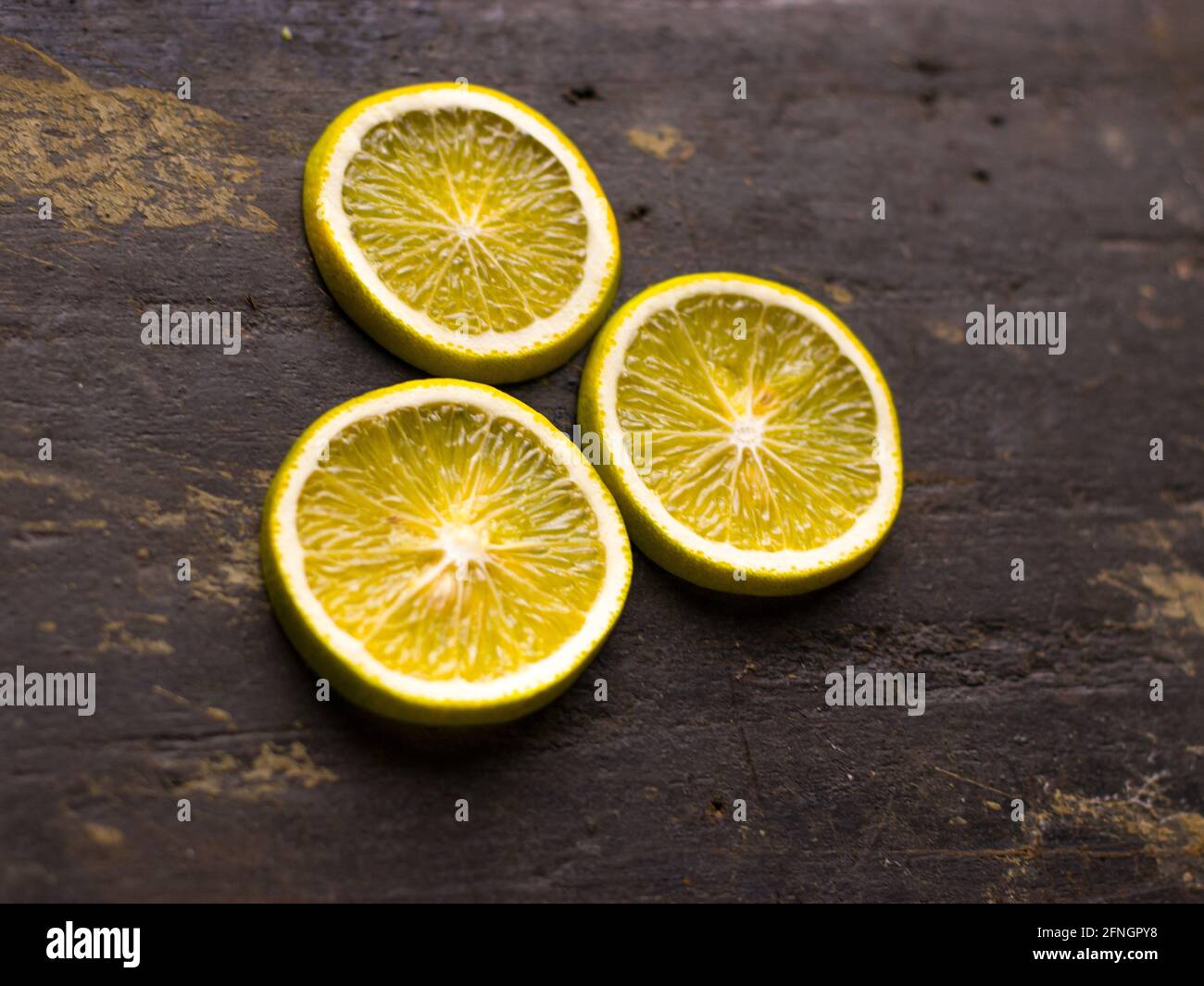 Fresh Mousambi OR Green lemon stock image on dark background. Stock Photo