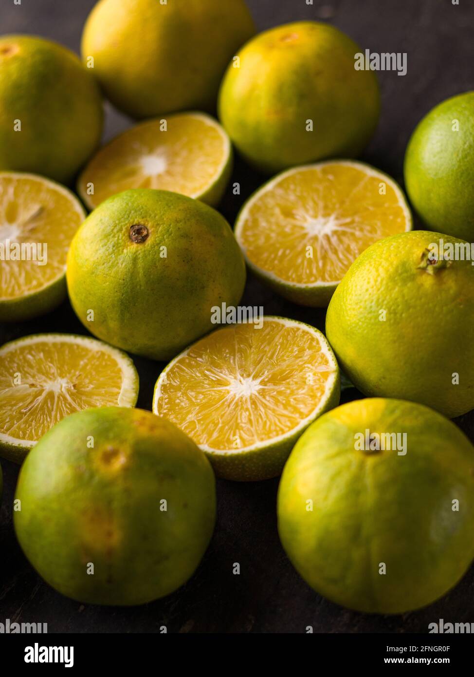 Fresh Mousambi OR Green lemon stock image on dark background. Stock Photo