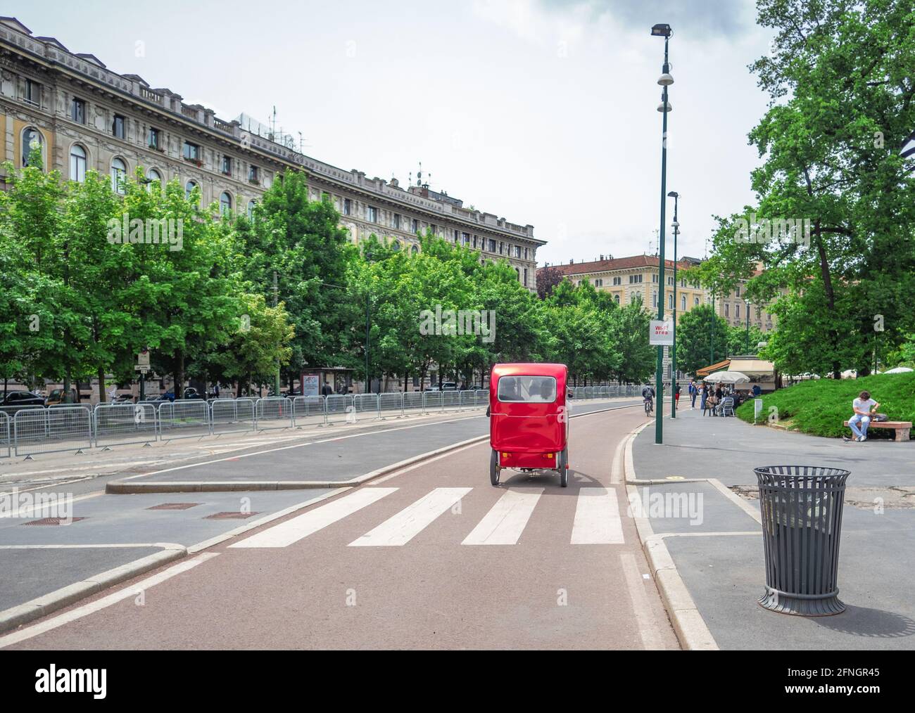 ecological pedal taxi on the bike path in the center of Milan.Sustainable zero emissions tourism, Lombardy, Italy. Stock Photo