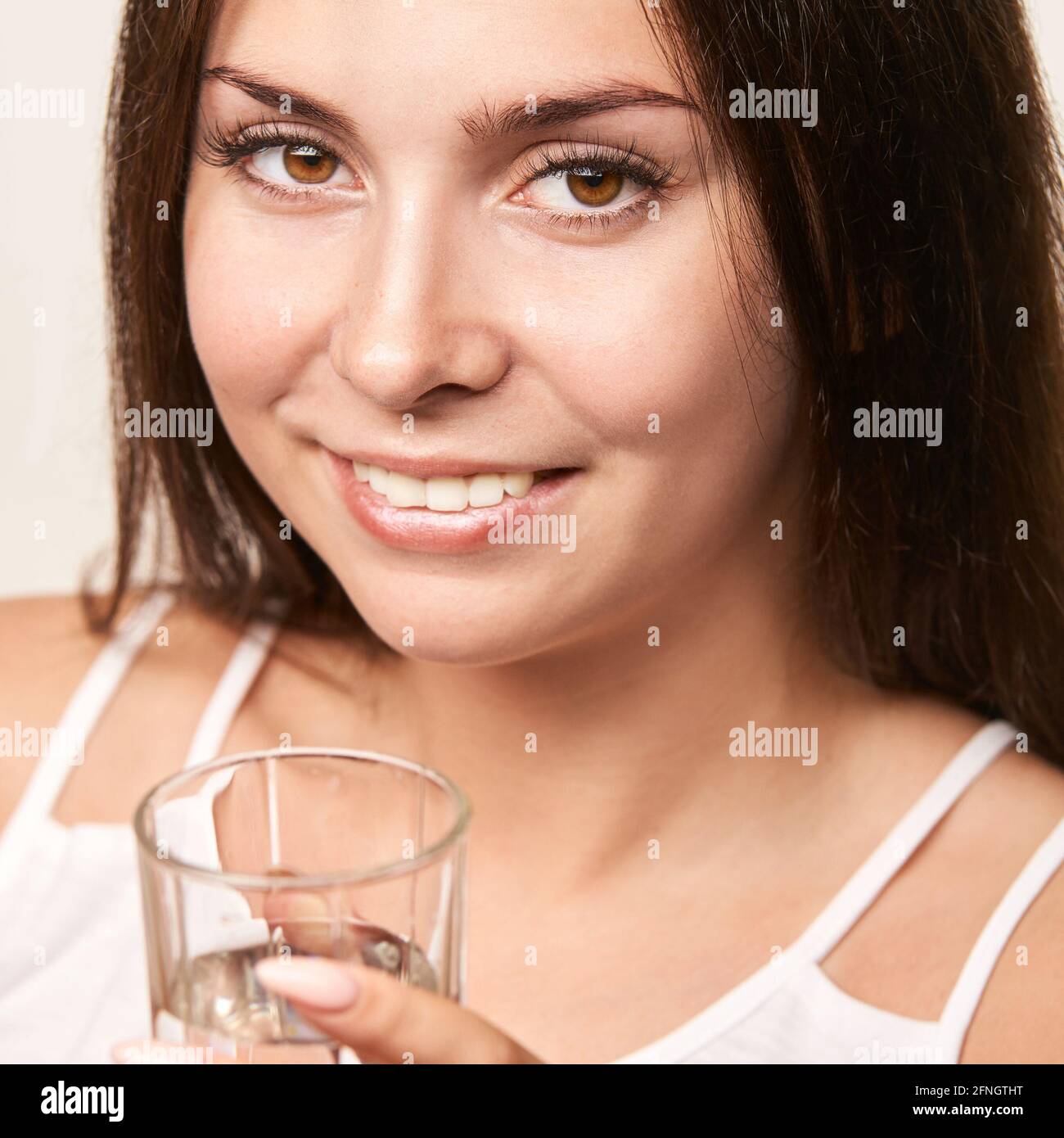 Girl drink water on white background. People lifestyle concept. Beauty