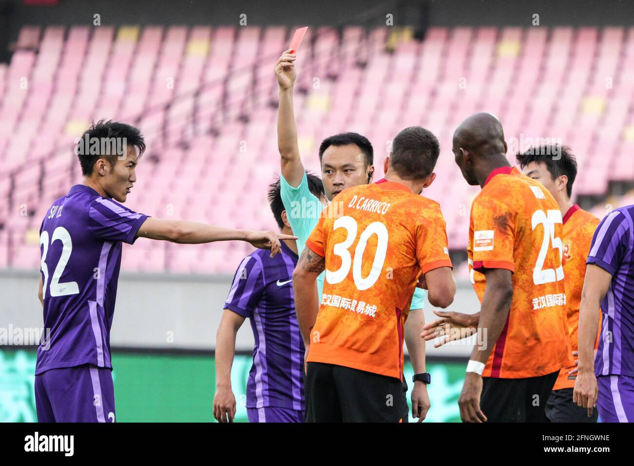 Jiangyin, China's Jiangsu Province. 17th May, 2021. Stephane M'Bia (2nd R) of Wuhan gets a red card during a 2021 season Chinese Football Association Super League (CSL) match between Tianjin and Wuhan in Jiangyin, east China's Jiangsu Province, May 17, 2021. Credit: Yang Lei/Xinhua/Alamy Live News Stock Photo