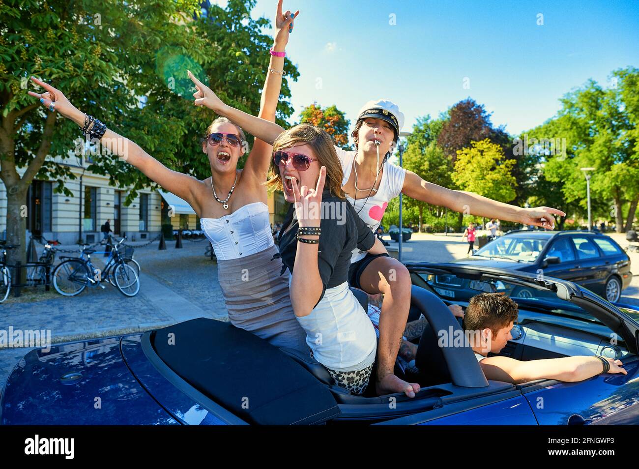 Young women having fun on a car in Stockholm Sweden Stock Photo