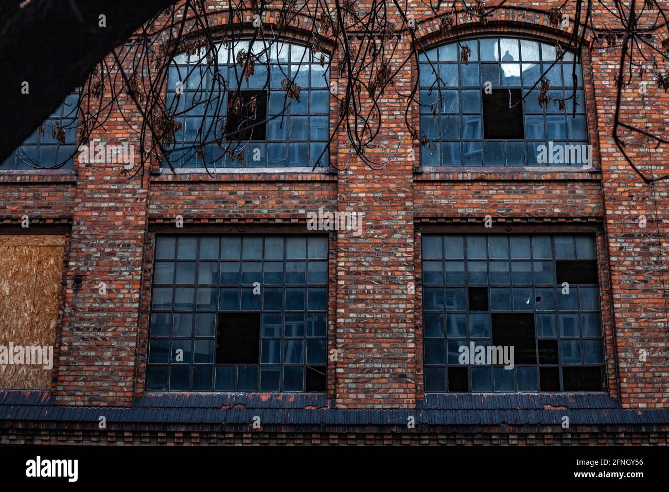 Abandoned brick building facade with broken windows Stock Photo - Alamy