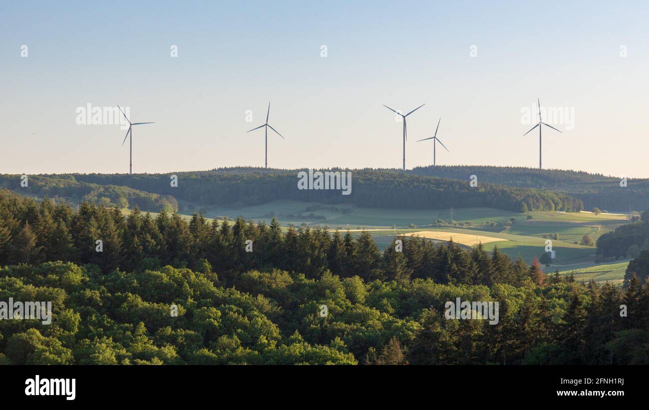 Wind Turbines in a Lush Green Landscape with Forests and Fields in ...