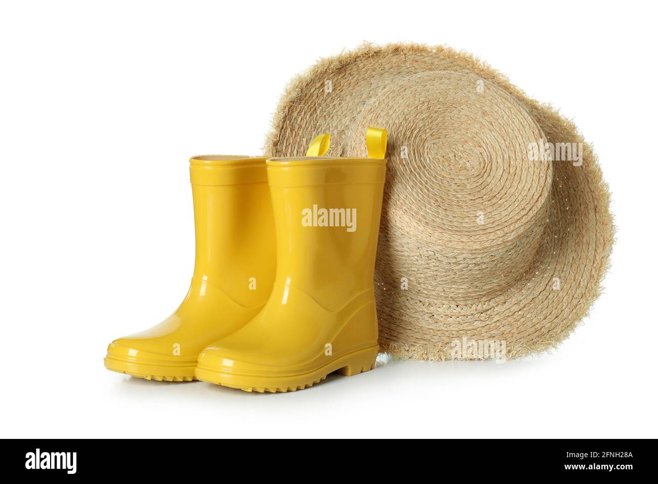 Rubber boots and straw hat isolated on white background Stock Photo