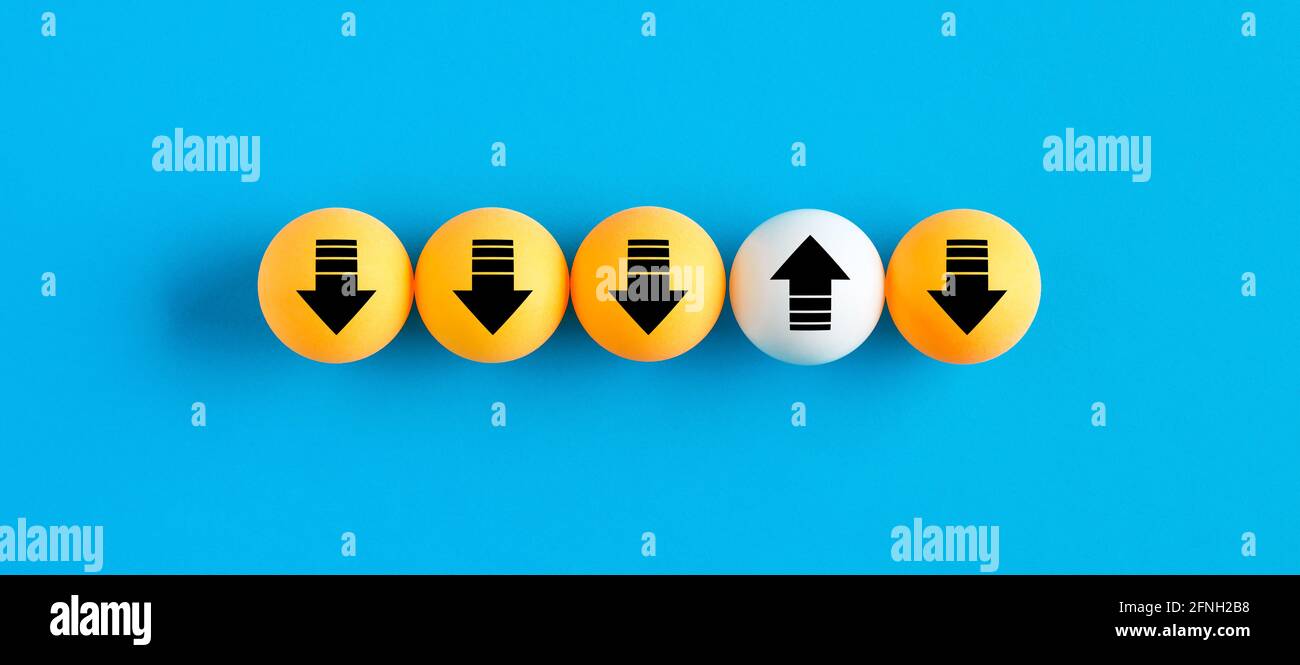 Arrow icons on table tennis balls in a row with one uploading while others are downloading. Network transfer, upload and download traffic concept. Stock Photo