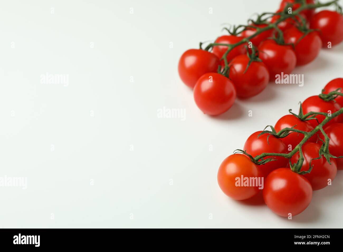 Fresh cherry tomato branches on white background Stock Photo - Alamy