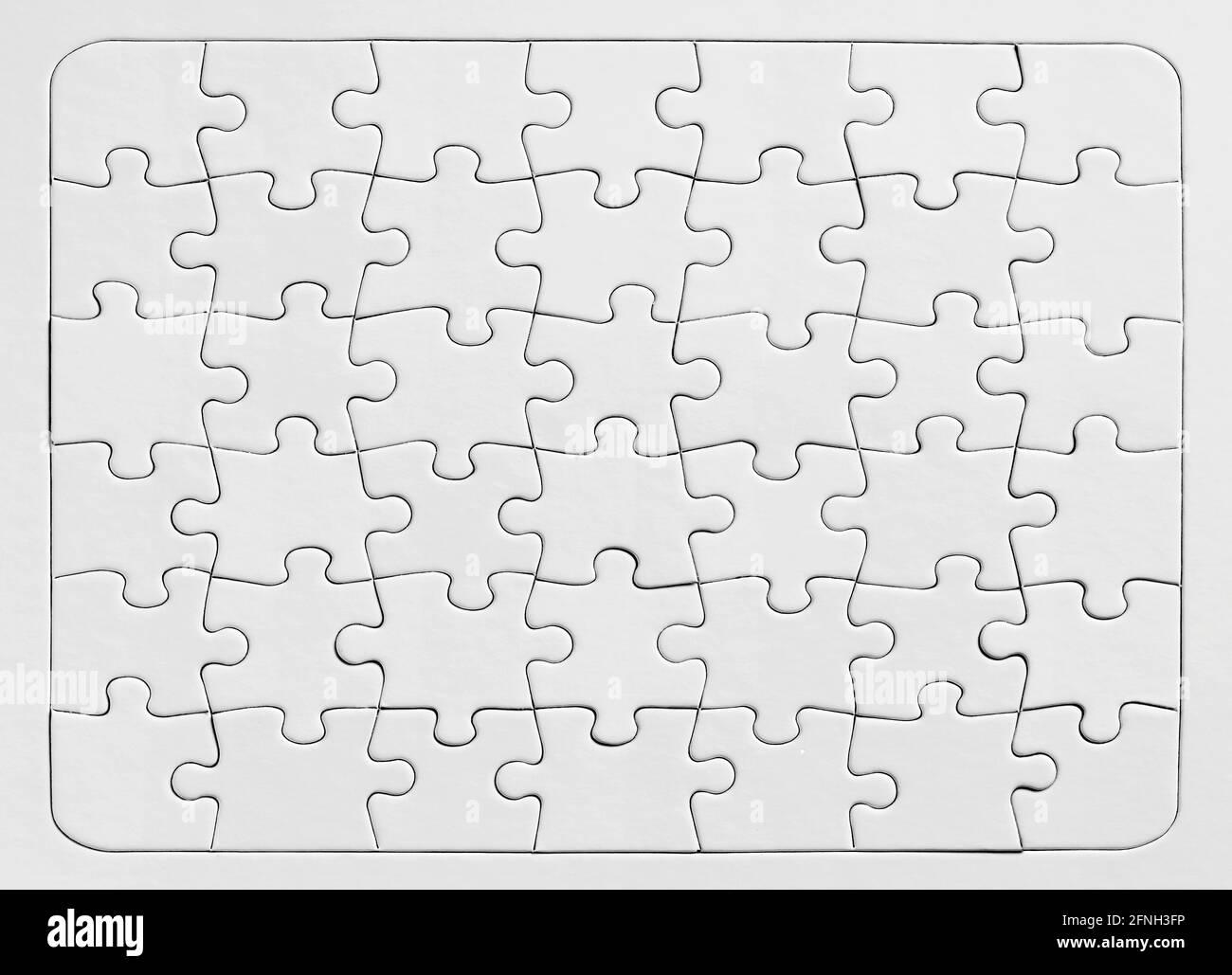 Blank or empty white jigsaw puzzle background. Overhead view with copy