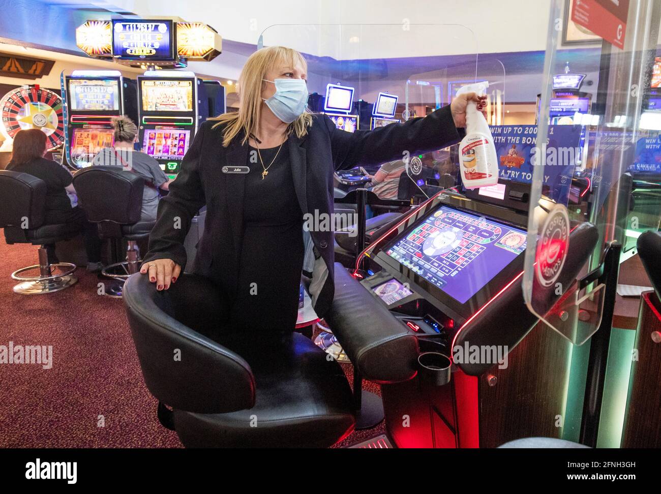 Electronic gaming manager Julie Baxter cleans the screens at the ...