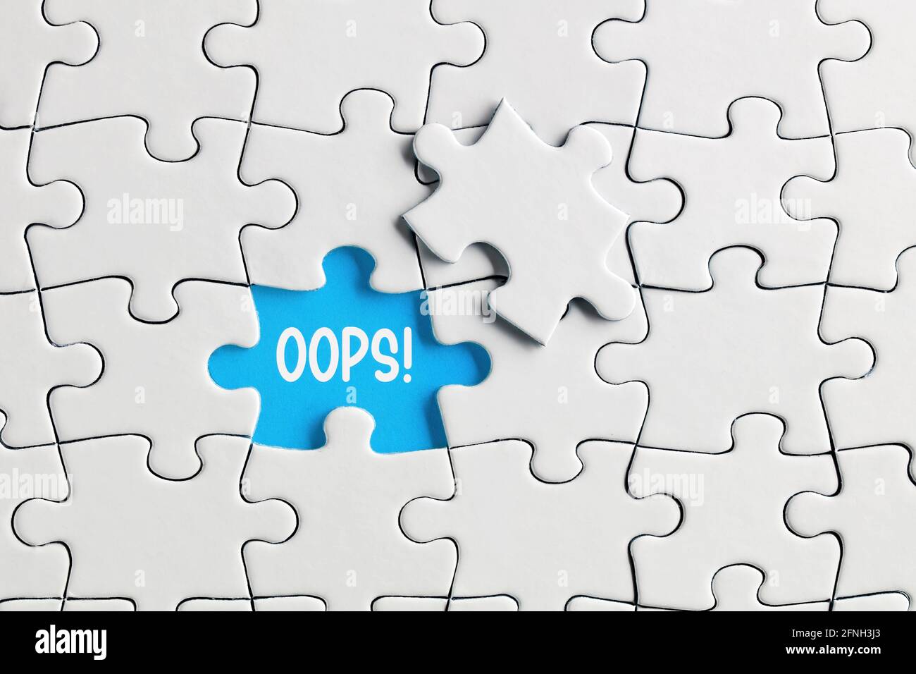Missing puzzle piece with the exclamation word oops. Mistake or error  concept Stock Photo - Alamy