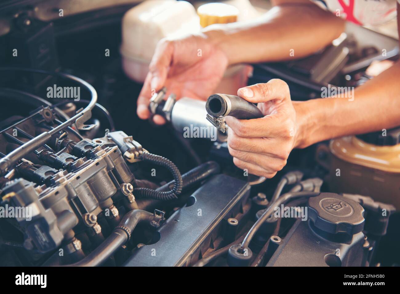 Mechanic Car Service in automobile garage auto car and vehicles service mechanical engineering. Automobile mechanic hands car repairs automotive works Stock Photo