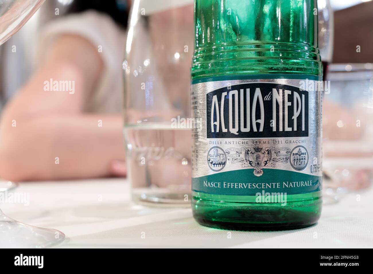 PORTO ROMANO, FIUMICINO, ITALY - JULY 15, 2020: Table setting with a bottle of Acqua di Nepi, a sparkling water found in most restaurants Stock Photo