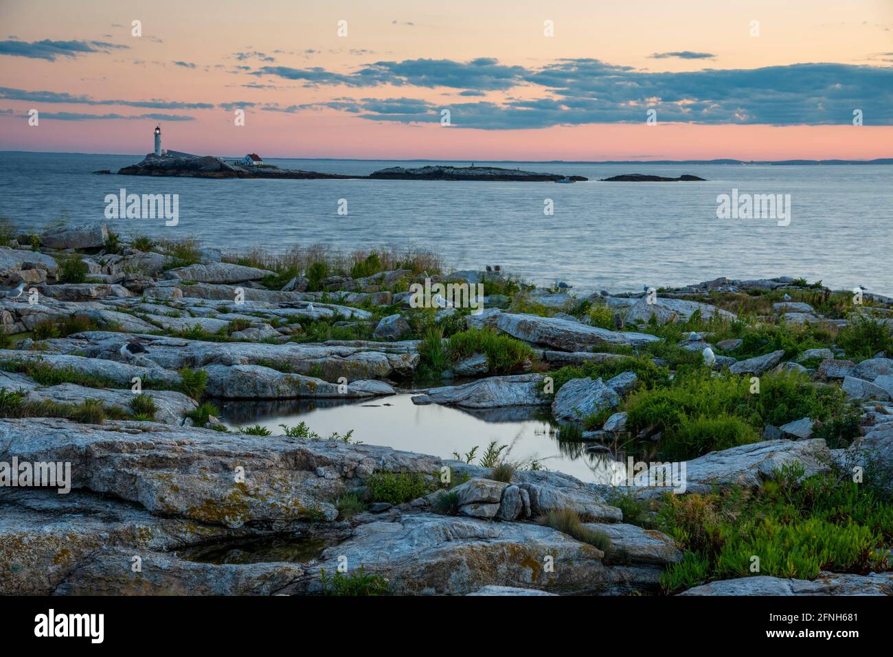 Early morning sunrise shot of Star Island landscape in New Hampshire with a view of the White Island Lighthouse. Stock Photo