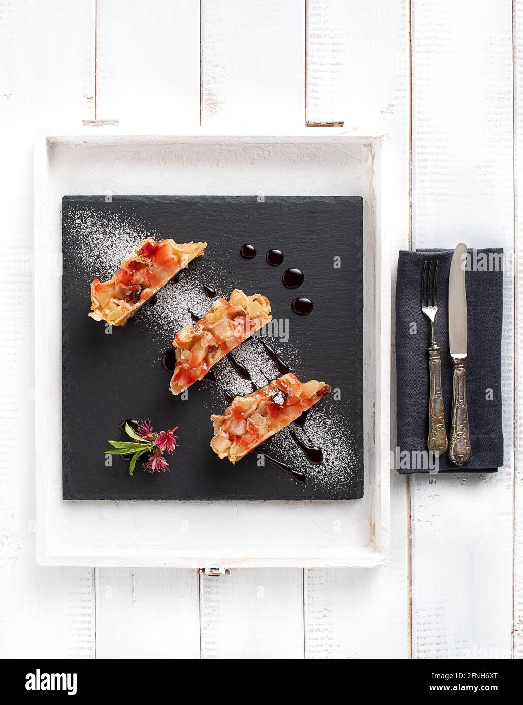 Slices of apple strudel on piece of slate photographed from above Stock Photo
