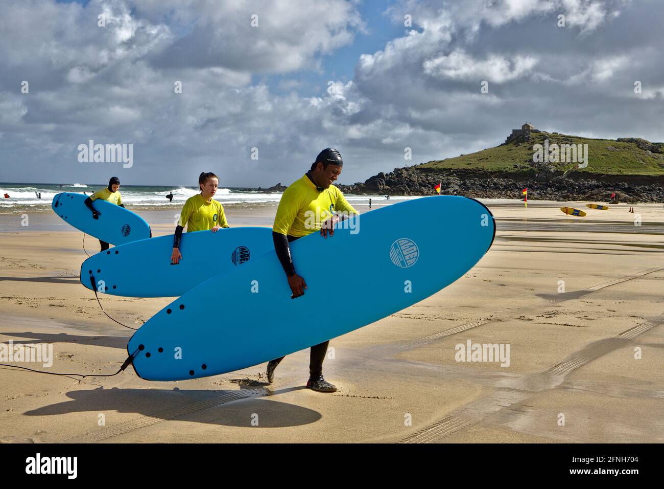 Morning surfers on Porthmeor Beach Cornwall Stock Photo