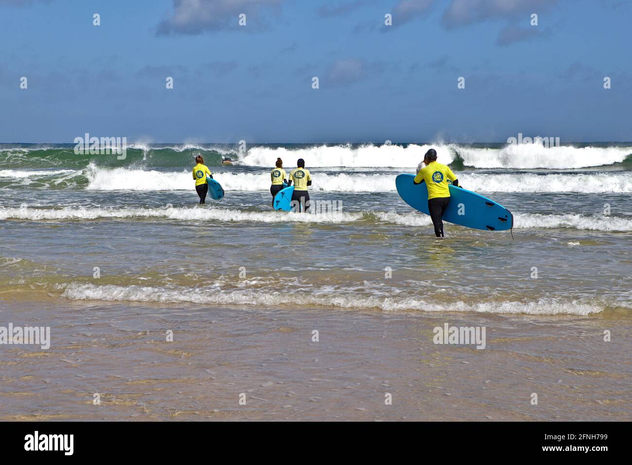 Morning surfers on Porthmeor Beach Cornwall Stock Photo