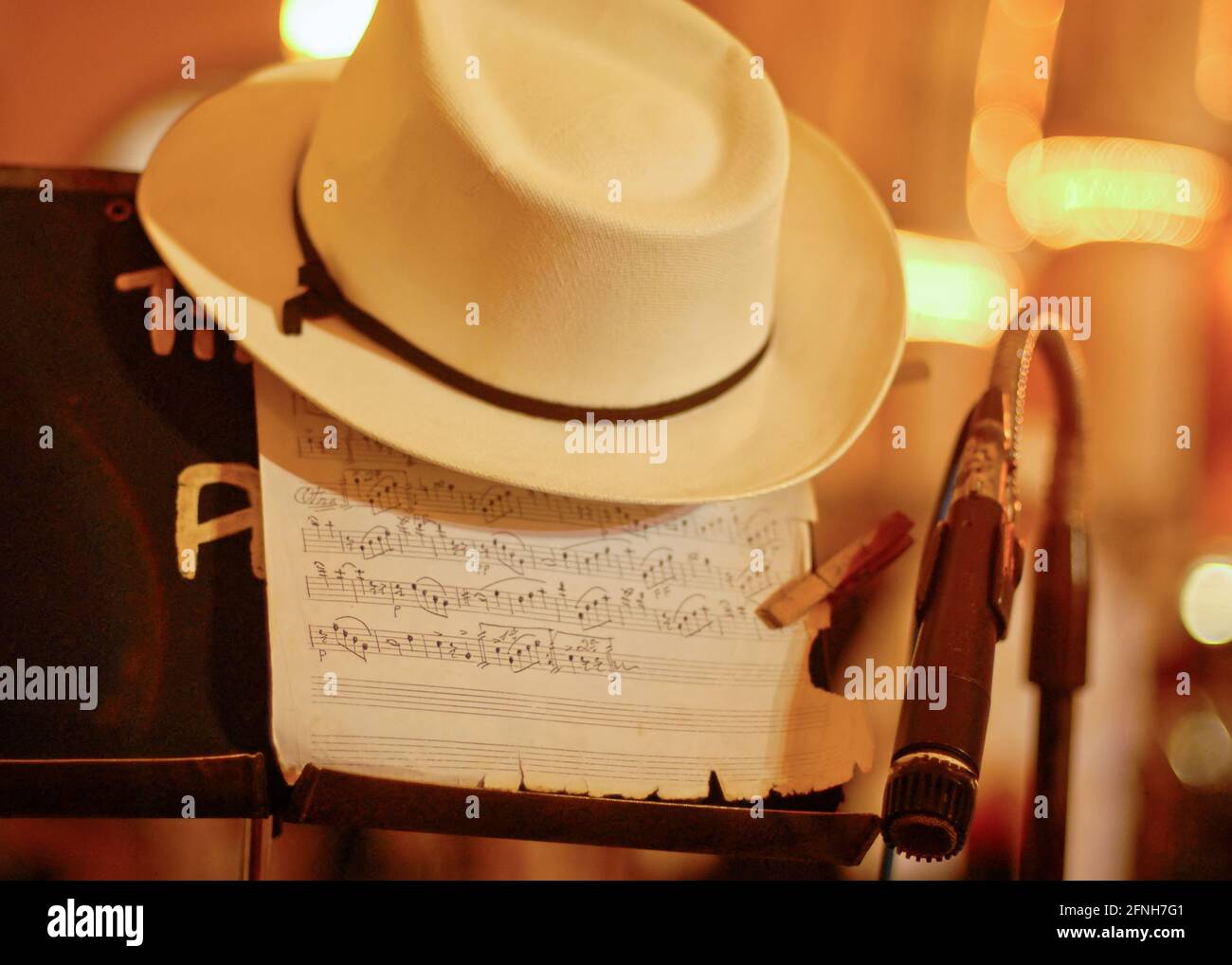 Closeup of a microphone with a musical note in the background and an elegant linen Panama hat, in the city of Merida in Mexico Stock Photo