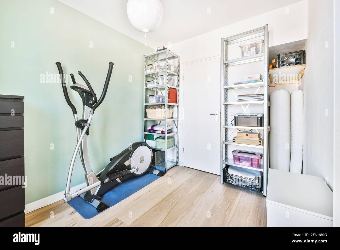 Step machine and shelves in home gym Stock Photo
