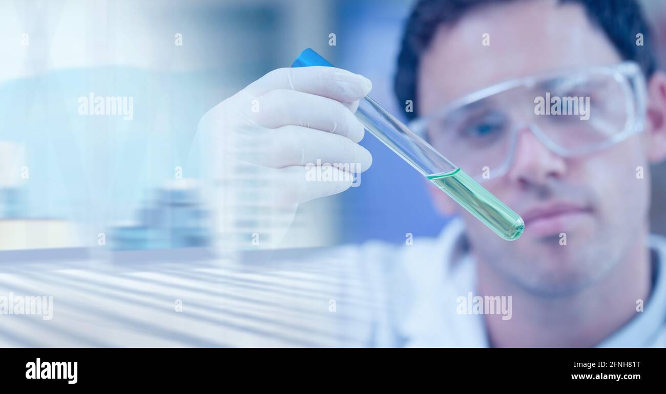 Composition of male scientist in lab using test tube with motion blur Stock Photo