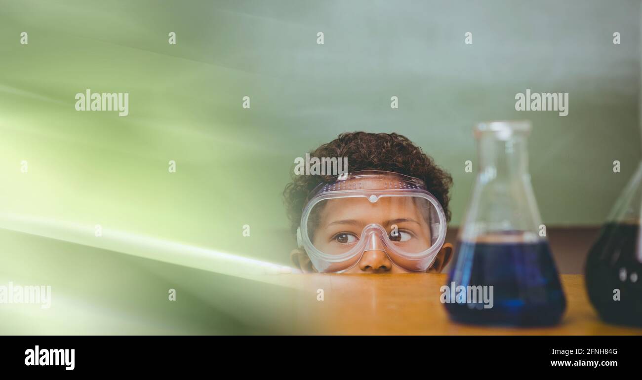 Composition of african american boy in lab with flasks, wearing goggles with motion blur Stock Photo