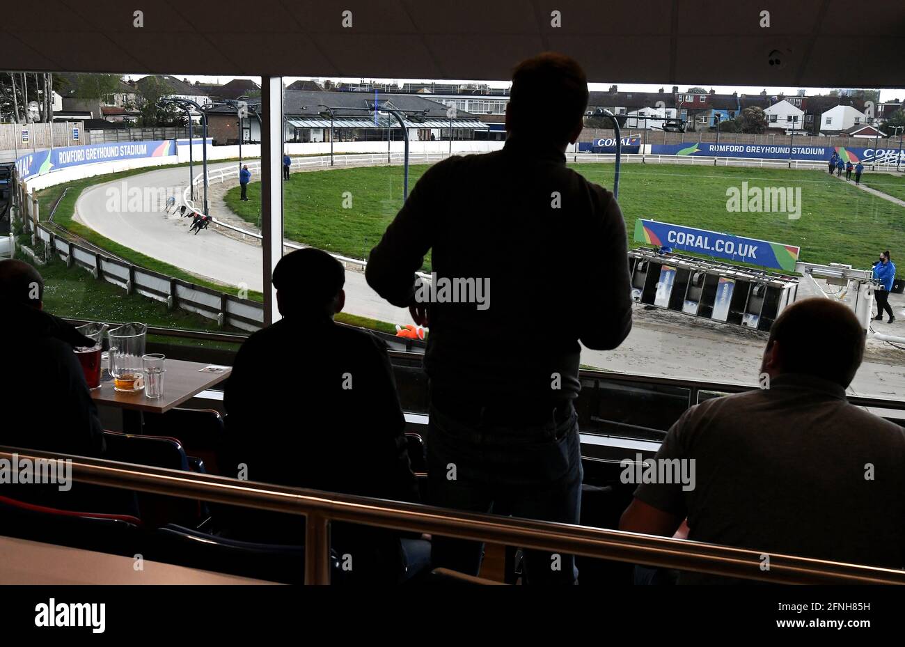 Spectators watch the action at Coral Romford Greyhound Stadium, Romford. Picture date: Monday May 17, 2021. Fans return to sporting events following the further easing of lockdown restrictions in England Stock Photo