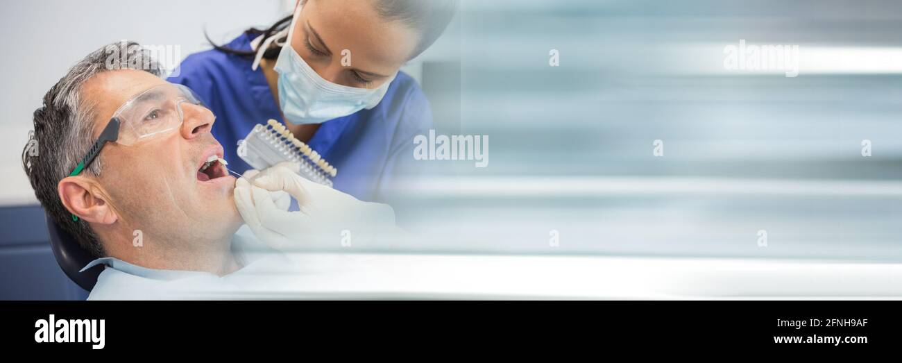 Composition of female dentist in face mask and male patient with blurred light trails Stock Photo