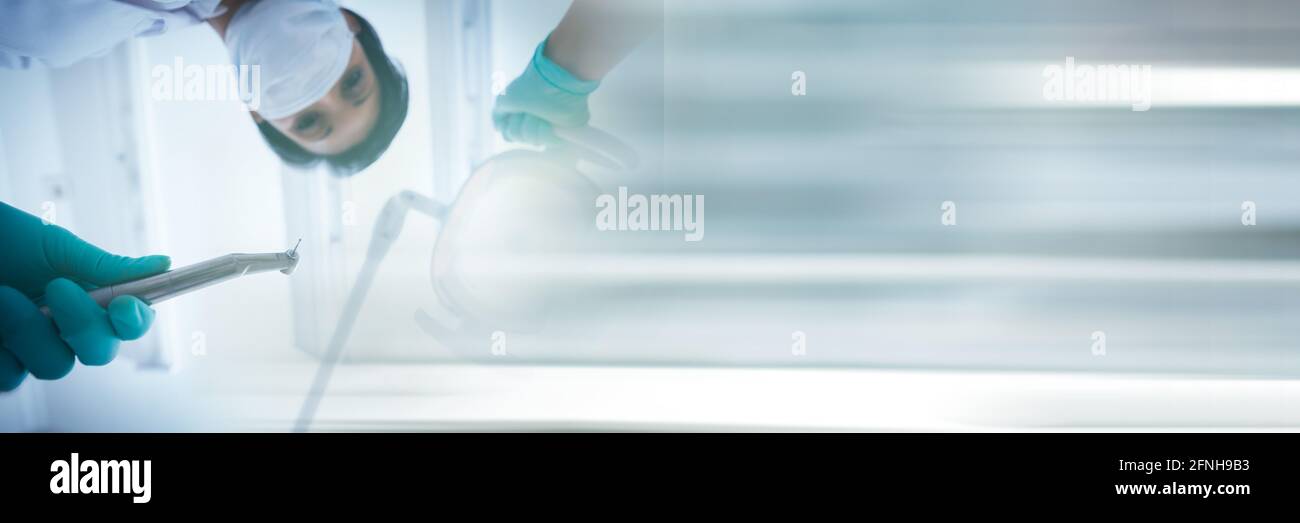 Composition of male dentist in face mask holding tools with blurred light trails Stock Photo