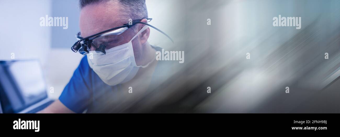 Composition of male dentist in face mask and protective glasses with blurred light trails Stock Photo