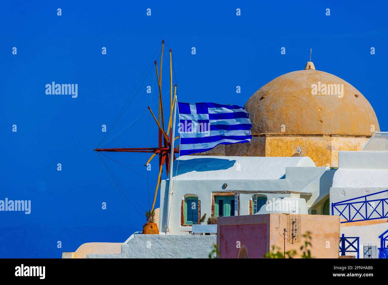 The national flag of Greece on the island of Santorini. Stock Photo